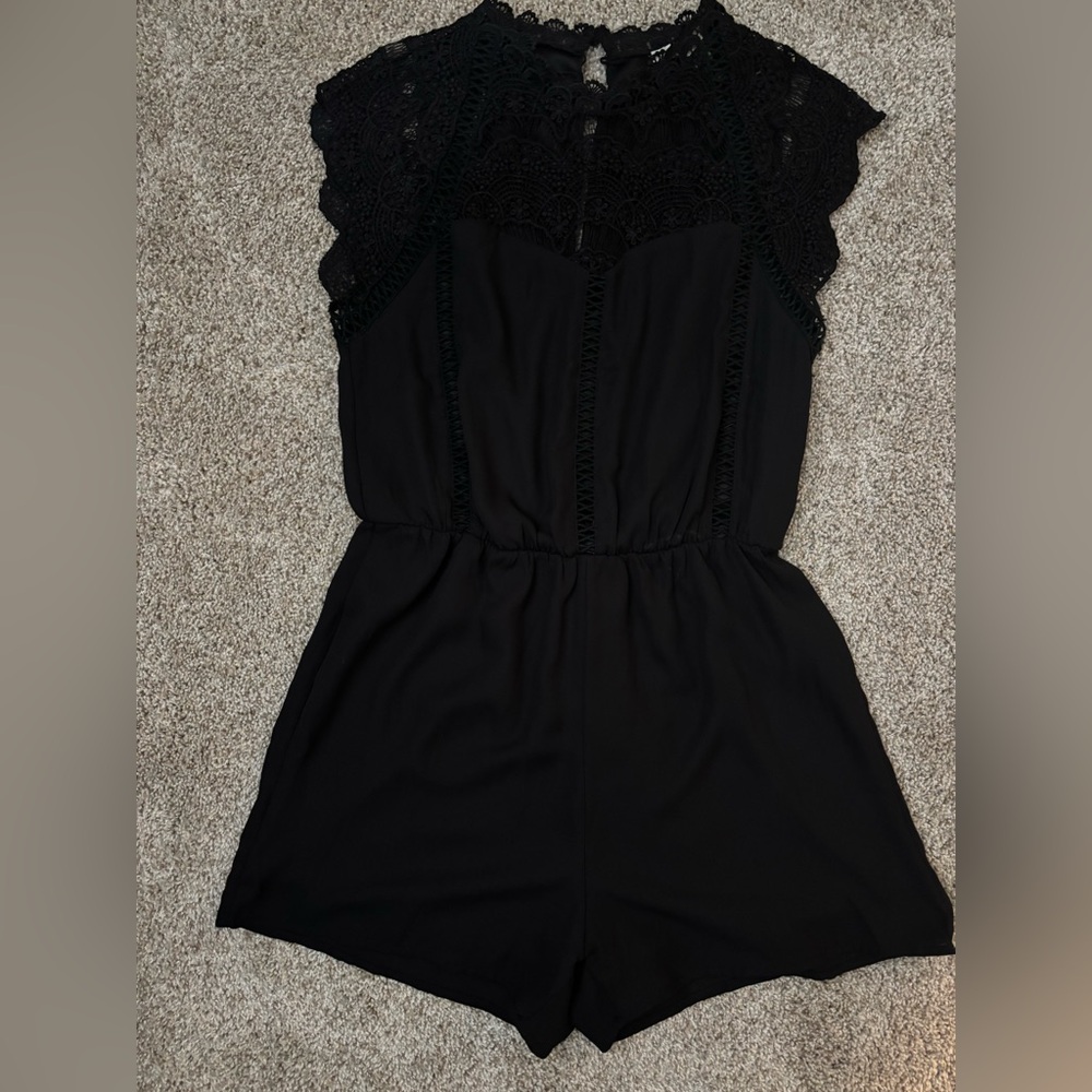 Francesca’s black romper with crochet detail